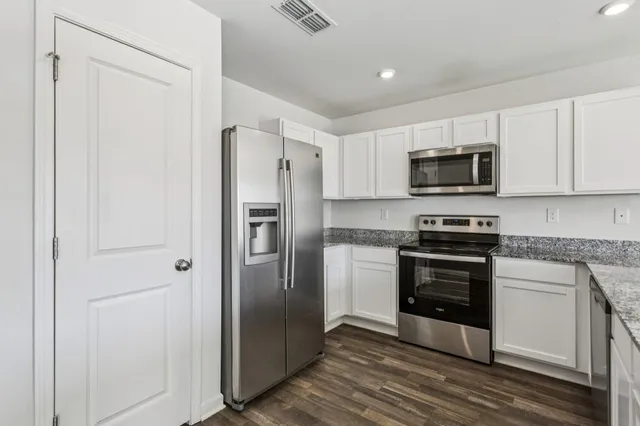 a kitchen with a refrigerator stove and microwave