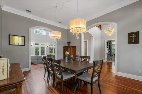 a view of a dining room with furniture and wooden floor