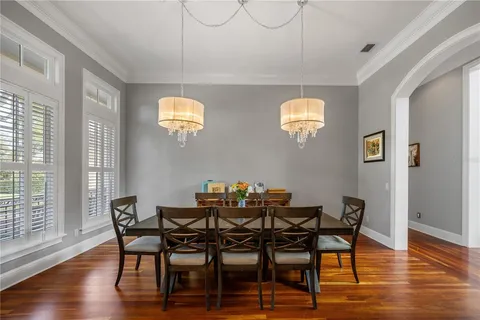 a view of a dining room with furniture window and wooden floor
