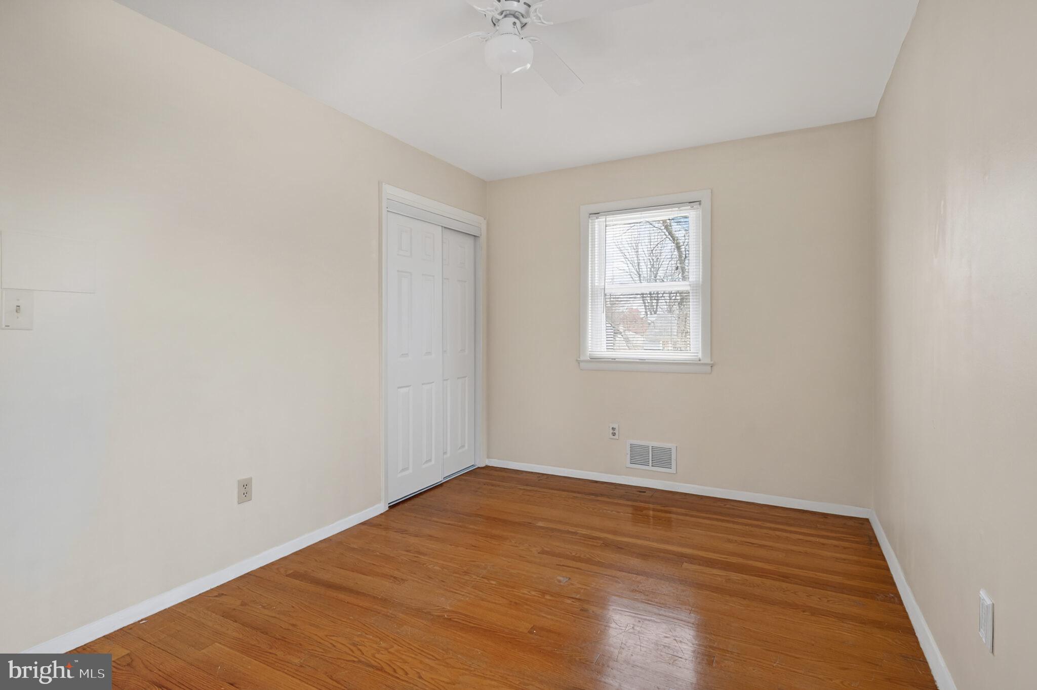 7507 Dover Lane Hyattsville, MD 20784 - Photo 26 of 53 an empty room with a window and a ceiling fan