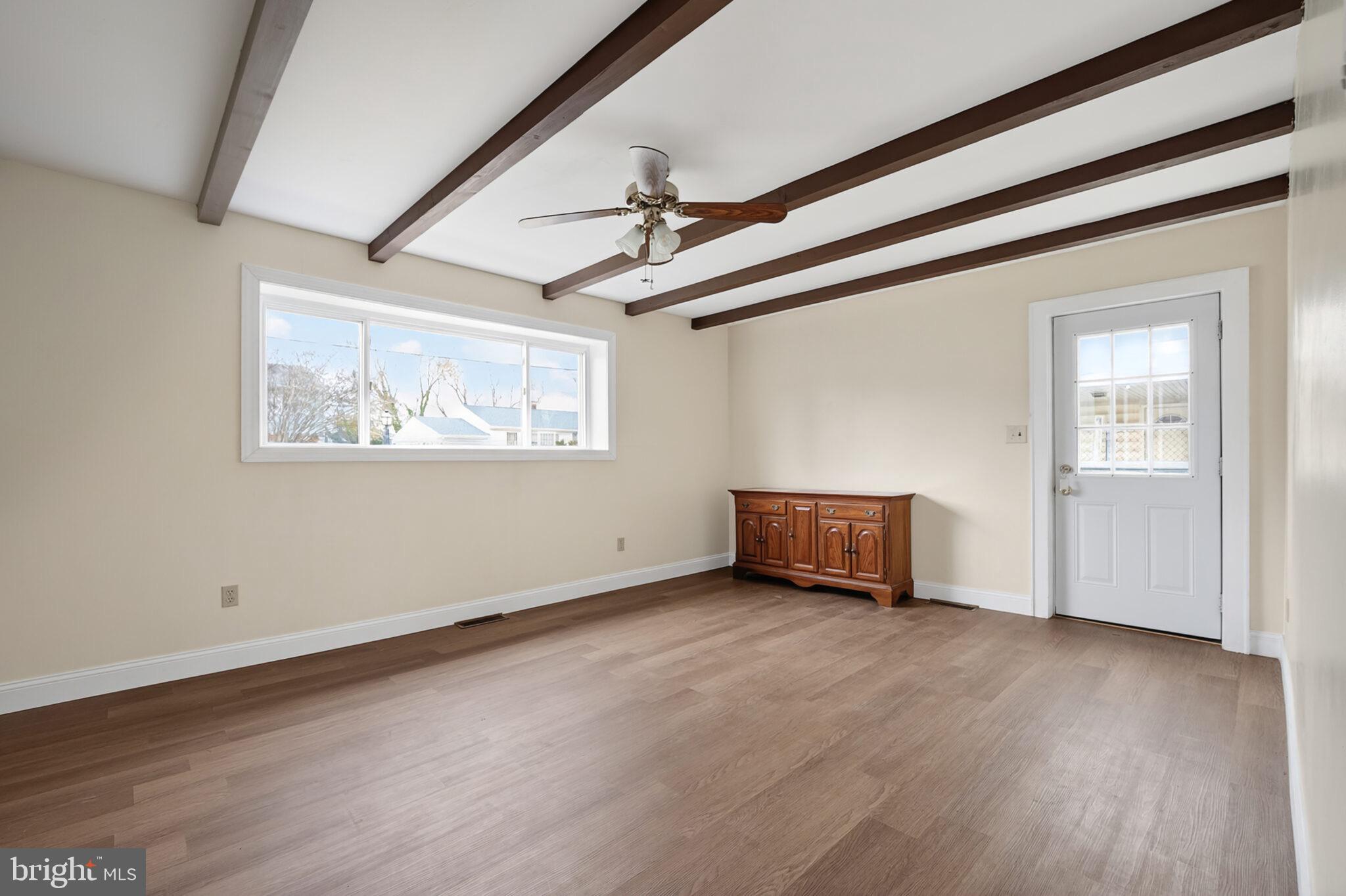 7507 Dover Lane Hyattsville, MD 20784 - Photo 30 of 53 a view of an empty room with wooden floor and a window