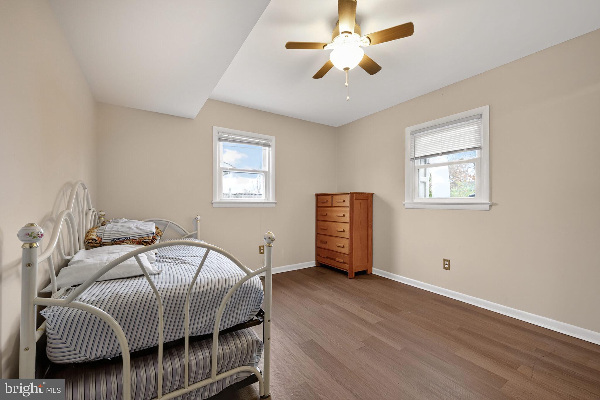 7507 Dover Lane Hyattsville, MD 20784 - Photo 32 of 53 a bedroom with a bed and wooden floor