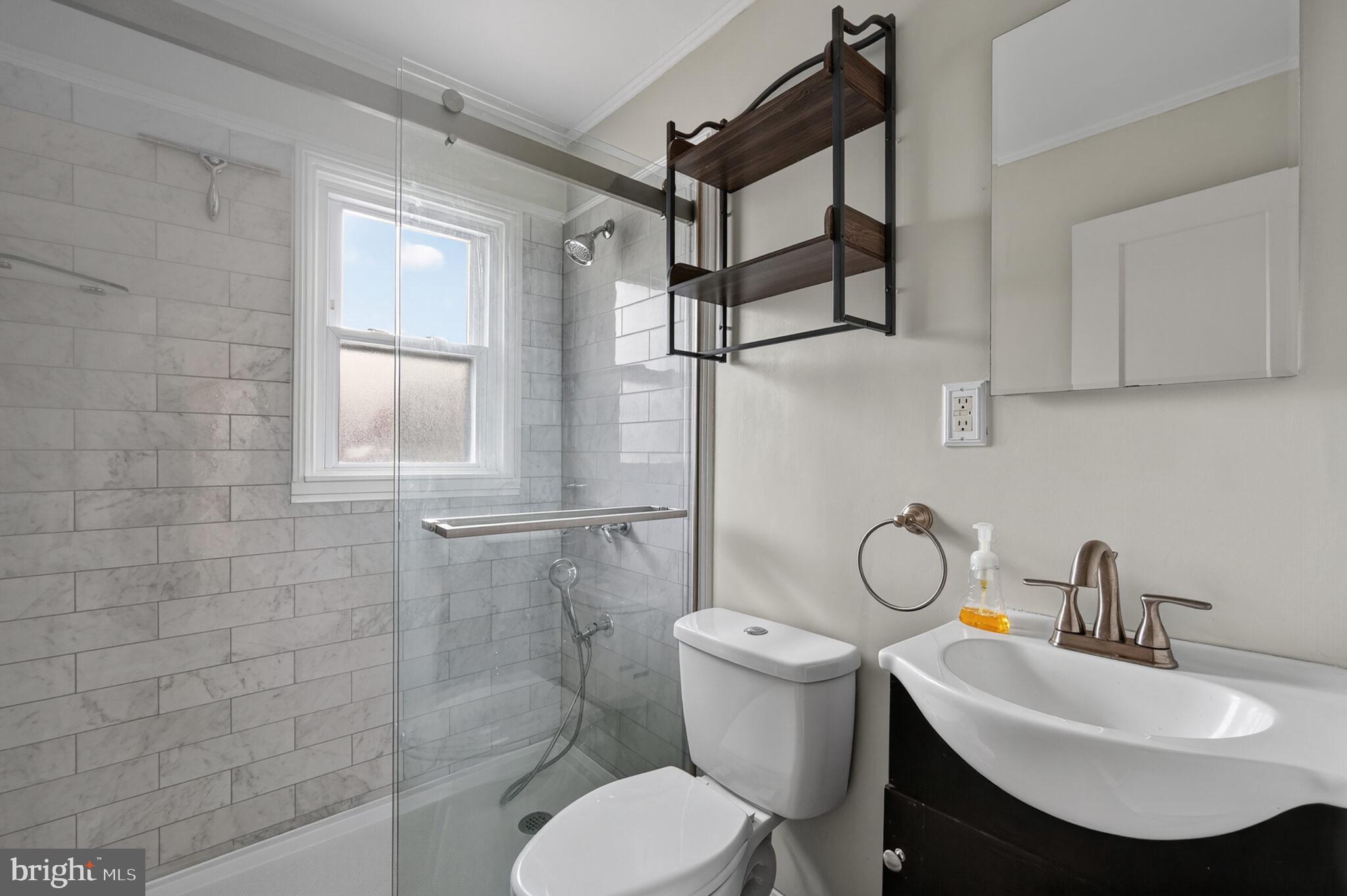 7507 Dover Lane Hyattsville, MD 20784 - Photo 34 of 53 a bathroom with a sink toilet and shower