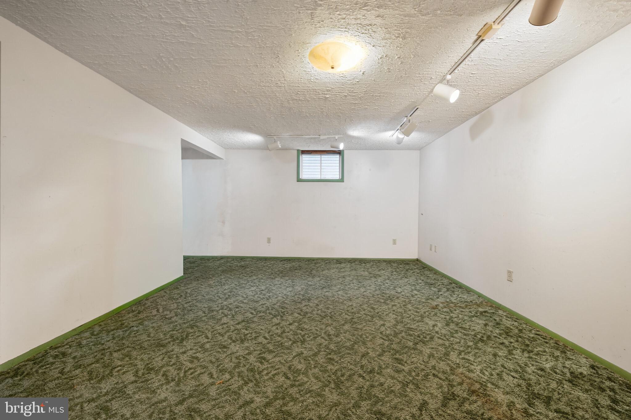 7507 Dover Lane Hyattsville, MD 20784 - Photo 37 of 53 an empty room with a ceiling fan and window
