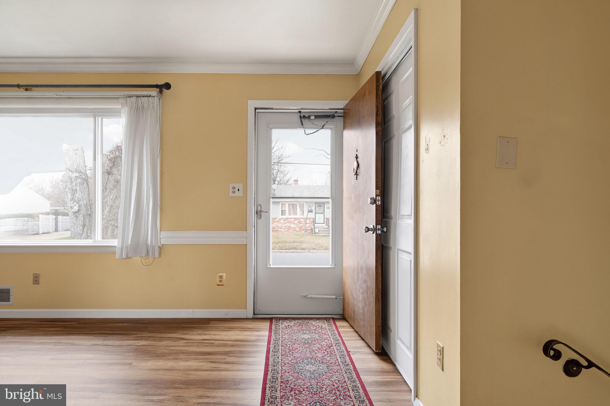 7507 Dover Lane Hyattsville, MD 20784 - Photo 4 of 53 a view of an empty room with wooden floor and a window