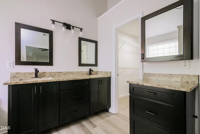 a bathroom with a double vanity sink and mirror