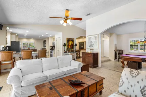 a room with pool table and a chandelier