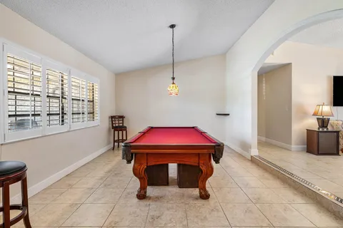a dining room with furniture and a chandelier
