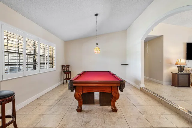 a dining room with furniture and a chandelier