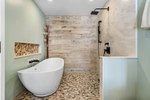 a bathroom with a granite countertop sink mirror vanity and toilet