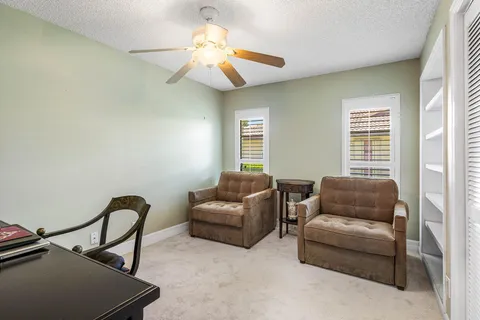 a bathroom with a granite countertop sink a toilet a mirror and shower