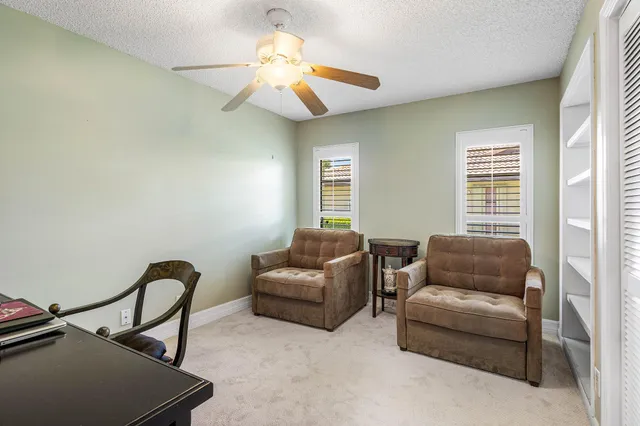 a bathroom with a granite countertop sink a toilet a mirror and shower
