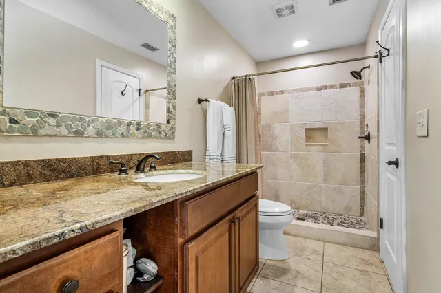 a bedroom with a bed and ceiling fan