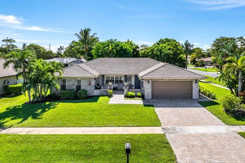 a aerial view of a house with swimming pool and yard with green space