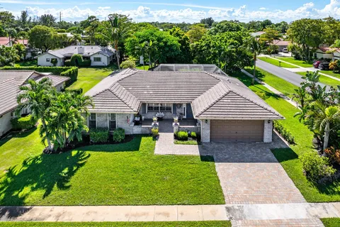 an aerial view of a house with a yard and potted plants