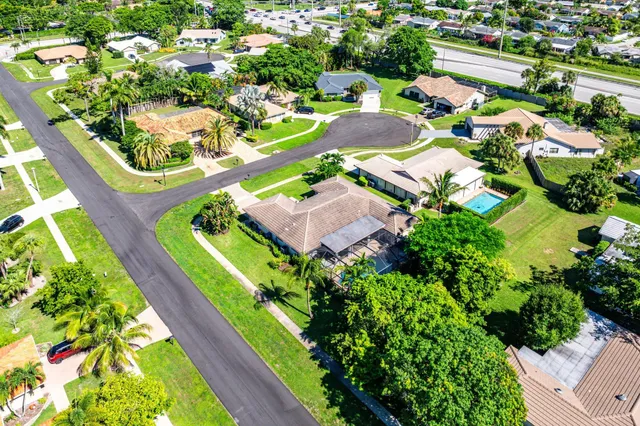 an aerial view of a house with a garden and swimming pool