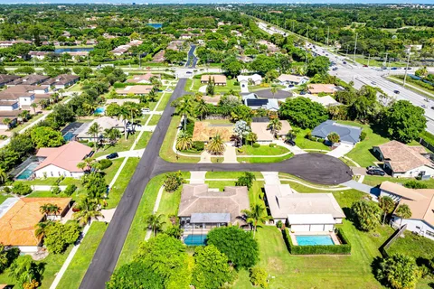 an aerial view of residential houses with outdoor space and street view