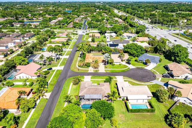 an aerial view of residential houses with outdoor space and street view