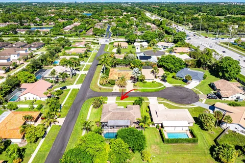 an aerial view of a house with a yard basket ball court and outdoor seating