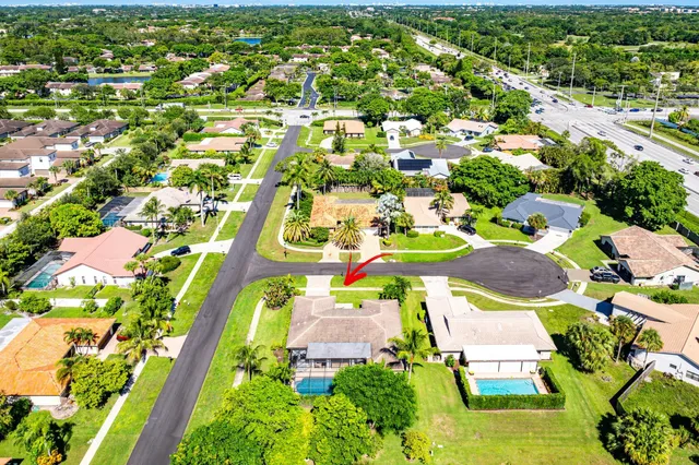 an aerial view of a house with a yard basket ball court and outdoor seating