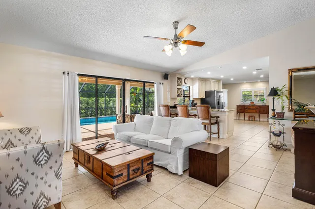 a view of a patio with a table chairs and a backyard