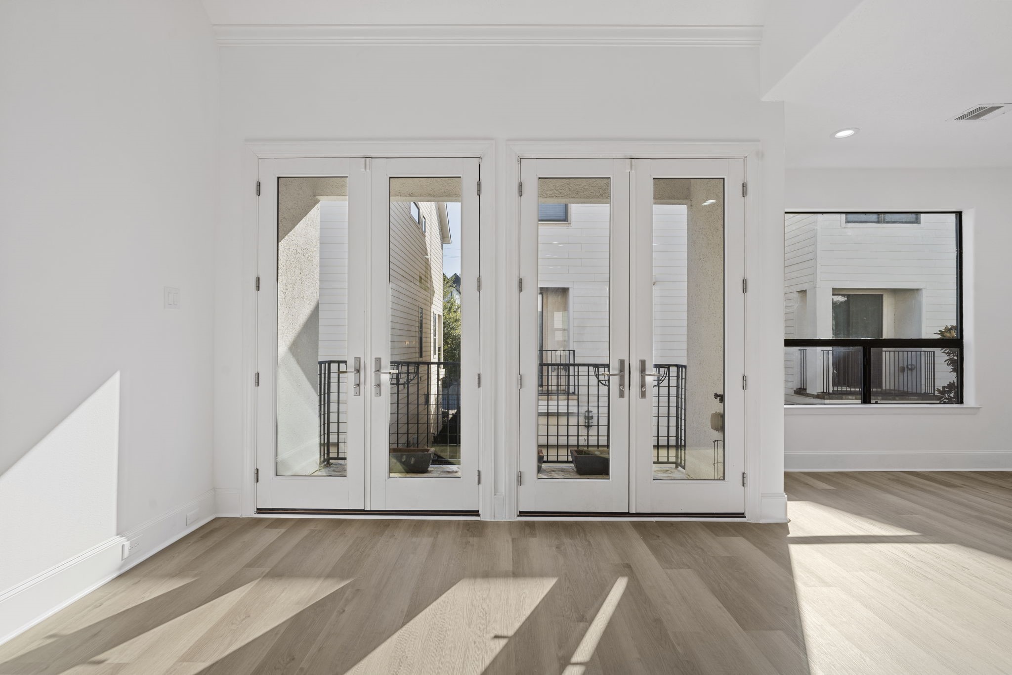 2547 Rusk Street Houston, TX 77003 - Photo 5 of 22 Elegant French doors from the living room lead to the front balcony.