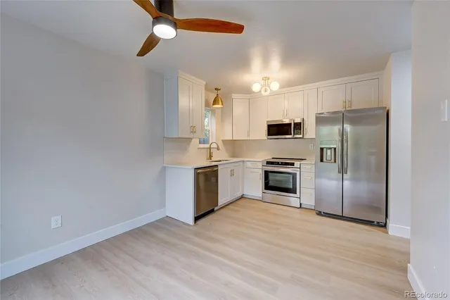 a kitchen with a refrigerator sink and microwave
