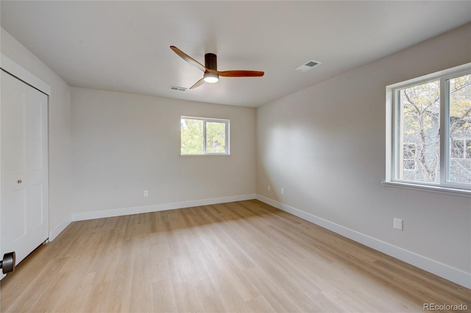 6495 Barnacle Court Boulder, CO 80301 - Photo 6 of 13 a view of an empty room with wooden floor and a window