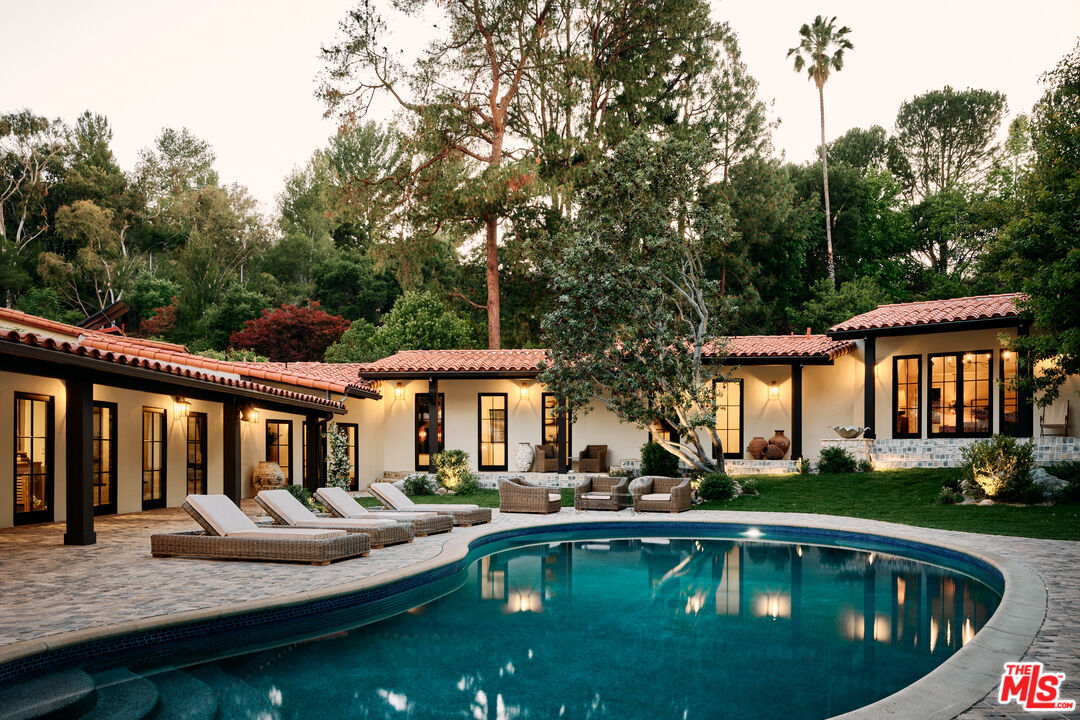 a view of a house with swimming pool and porch