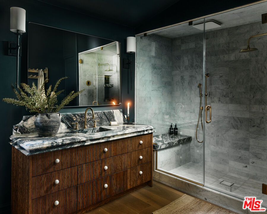 11945 Lockridge Road Studio City, CA 91604 - Photo 20 of 36 a bathroom with a granite countertop sink a mirror and shower
