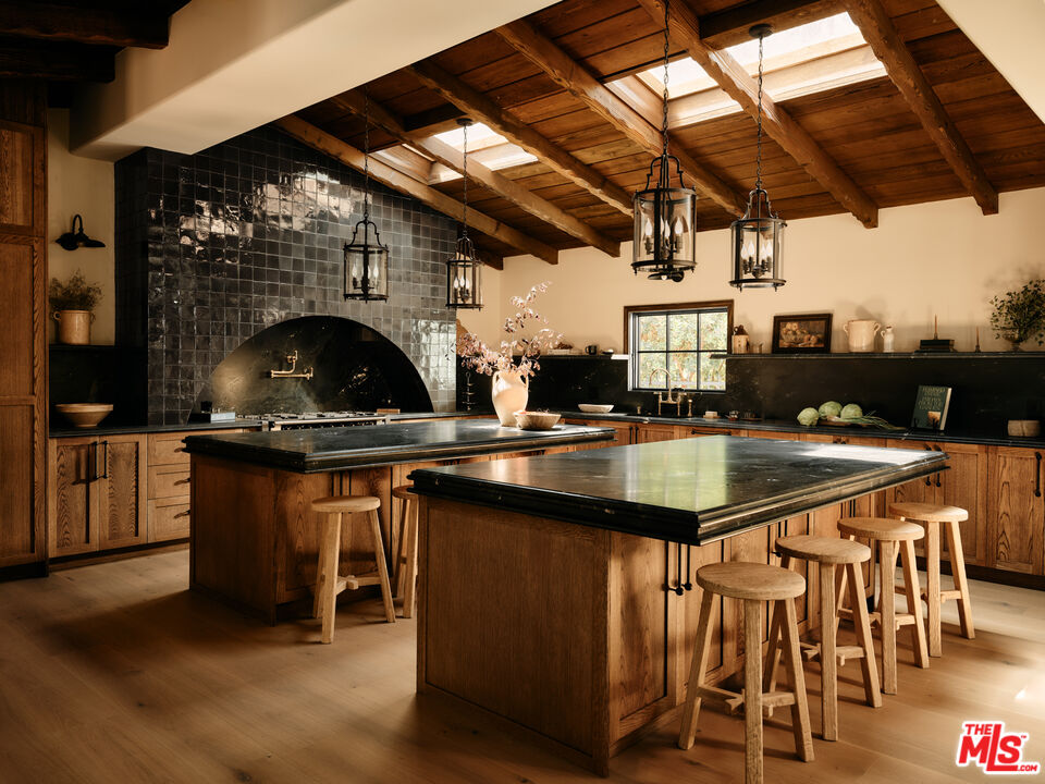 11945 Lockridge Road Studio City, CA 91604 - Photo 2 of 36 a kitchen with a sink a counter and chairs
