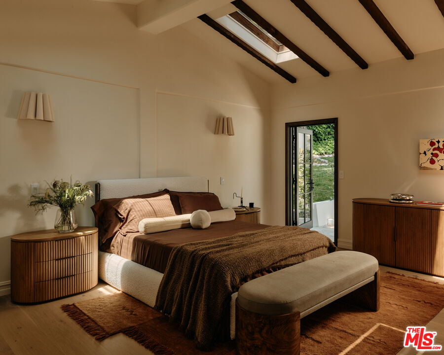 11945 Lockridge Road Studio City, CA 91604 - Photo 23 of 36 a bedroom with a bed and wooden floor