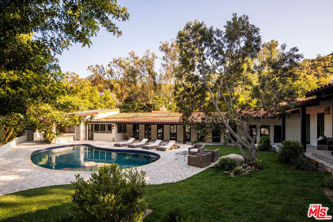 11945 Lockridge Road Studio City, CA 91604 - Photo 28 of 36 a view of a house with swimming pool and sitting area