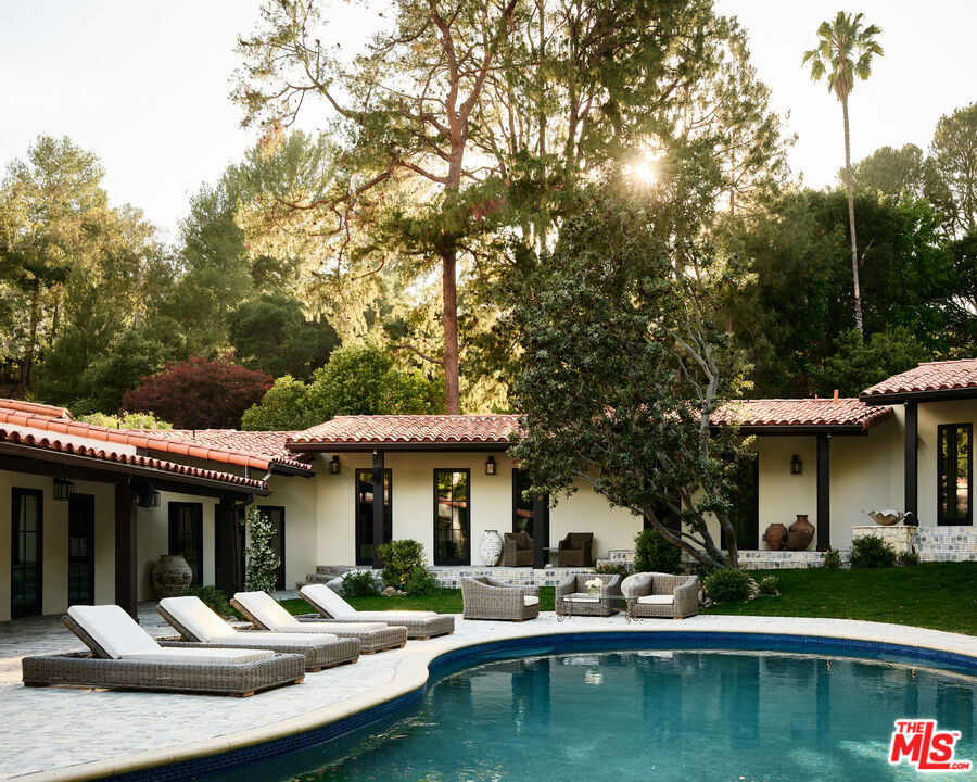 11945 Lockridge Road Studio City, CA 91604 - Photo 30 of 36 a front view of a house with swimming pool and a large garden