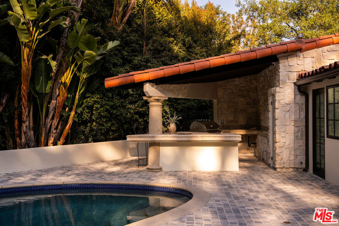 11945 Lockridge Road Studio City, CA 91604 - Photo 31 of 36 a view of swimming pool with a patio