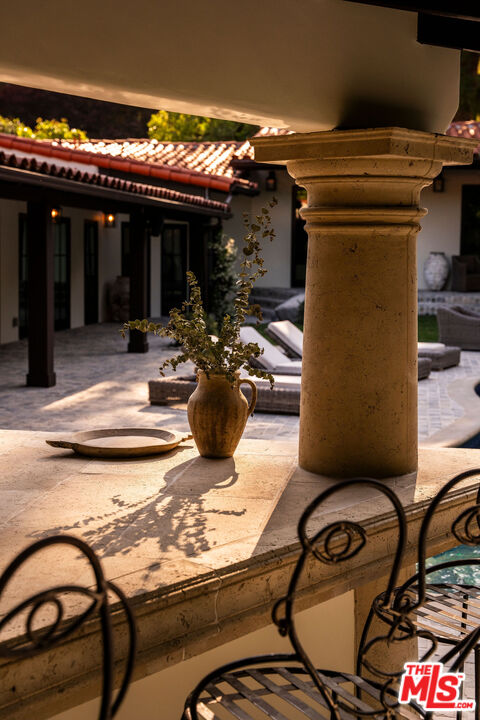 11945 Lockridge Road Studio City, CA 91604 - Photo 32 of 36 a view of a patio with table and chairs and potted plants