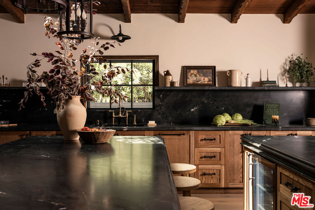 11945 Lockridge Road Studio City, CA 91604 - Photo 4 of 36 a kitchen with a table chairs and a stove