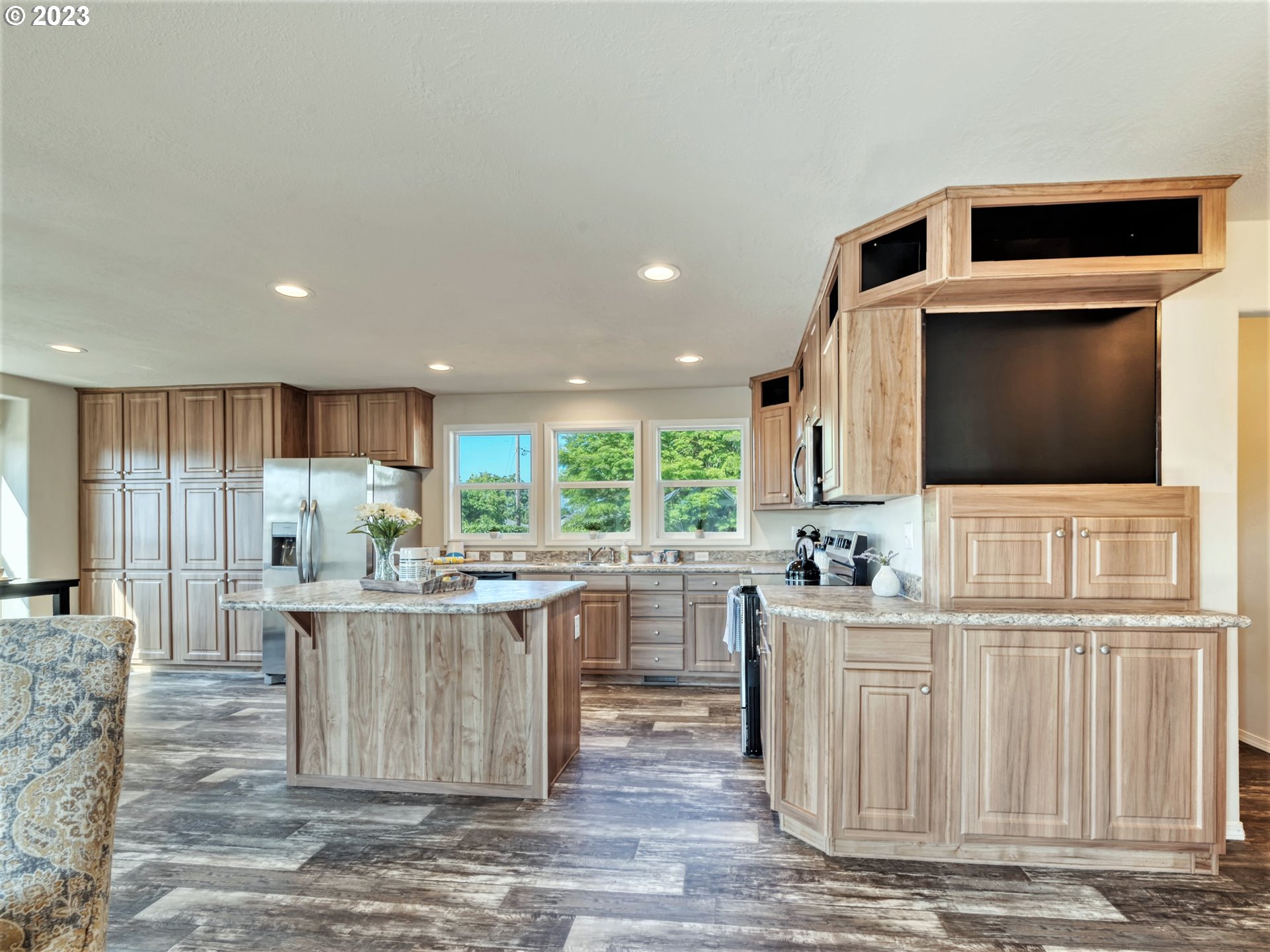 4689 Union Terrace Springfield, OR 97478 - Photo 11 of 24 a kitchen with stainless steel appliances kitchen island granite countertop a sink and cabinets