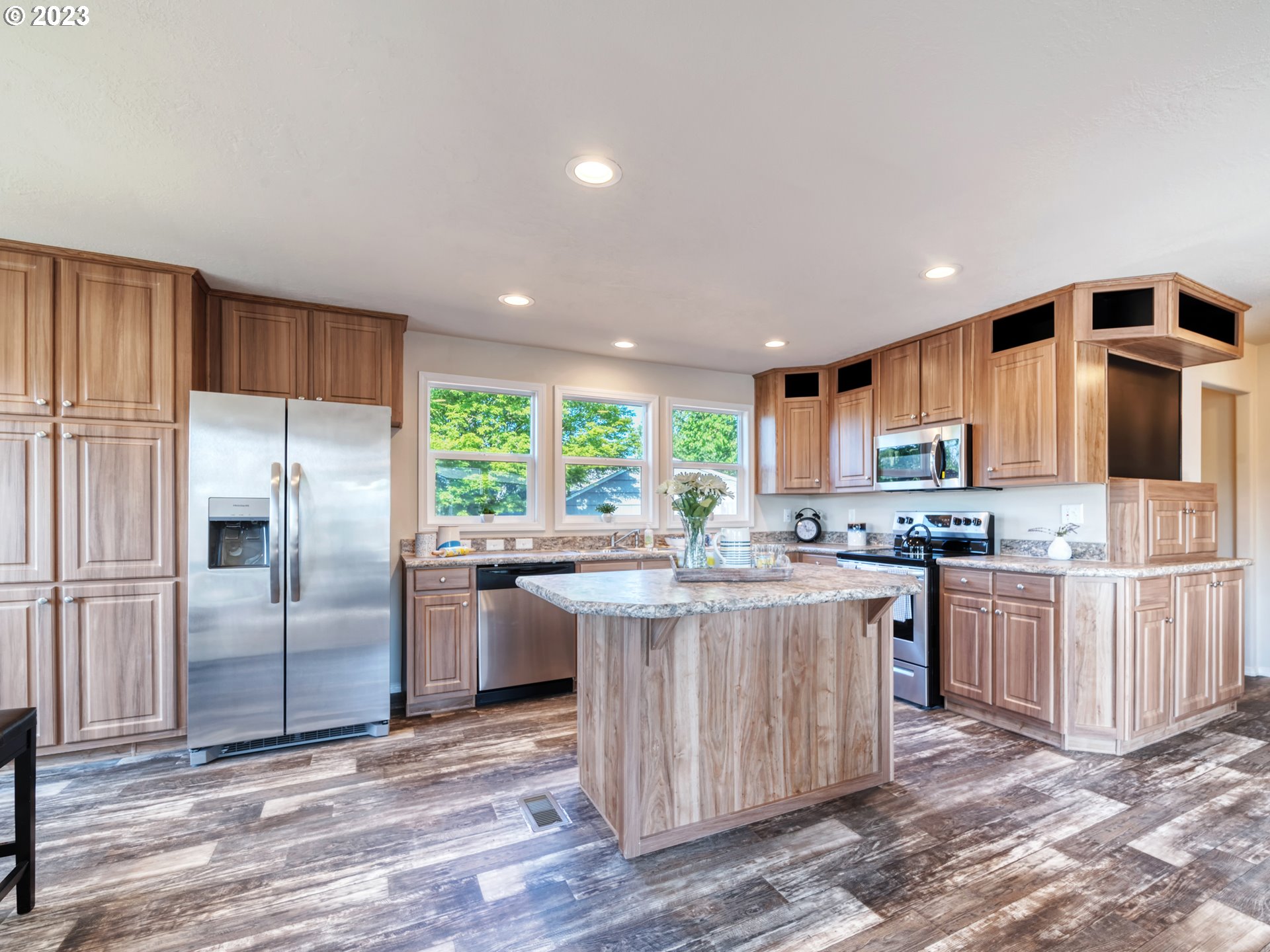 4689 Union Terrace Springfield, OR 97478 - Photo 5 of 24 a kitchen with kitchen island granite countertop a sink stove and refrigerator