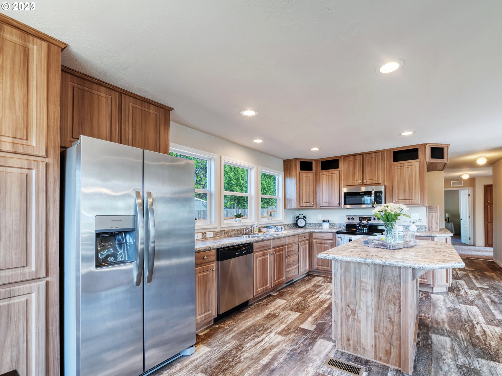 4689 Union Terrace Springfield, OR 97478 - Photo 6 of 24 a kitchen with stainless steel appliances granite countertop a refrigerator a stove a sink a dining table and chairs