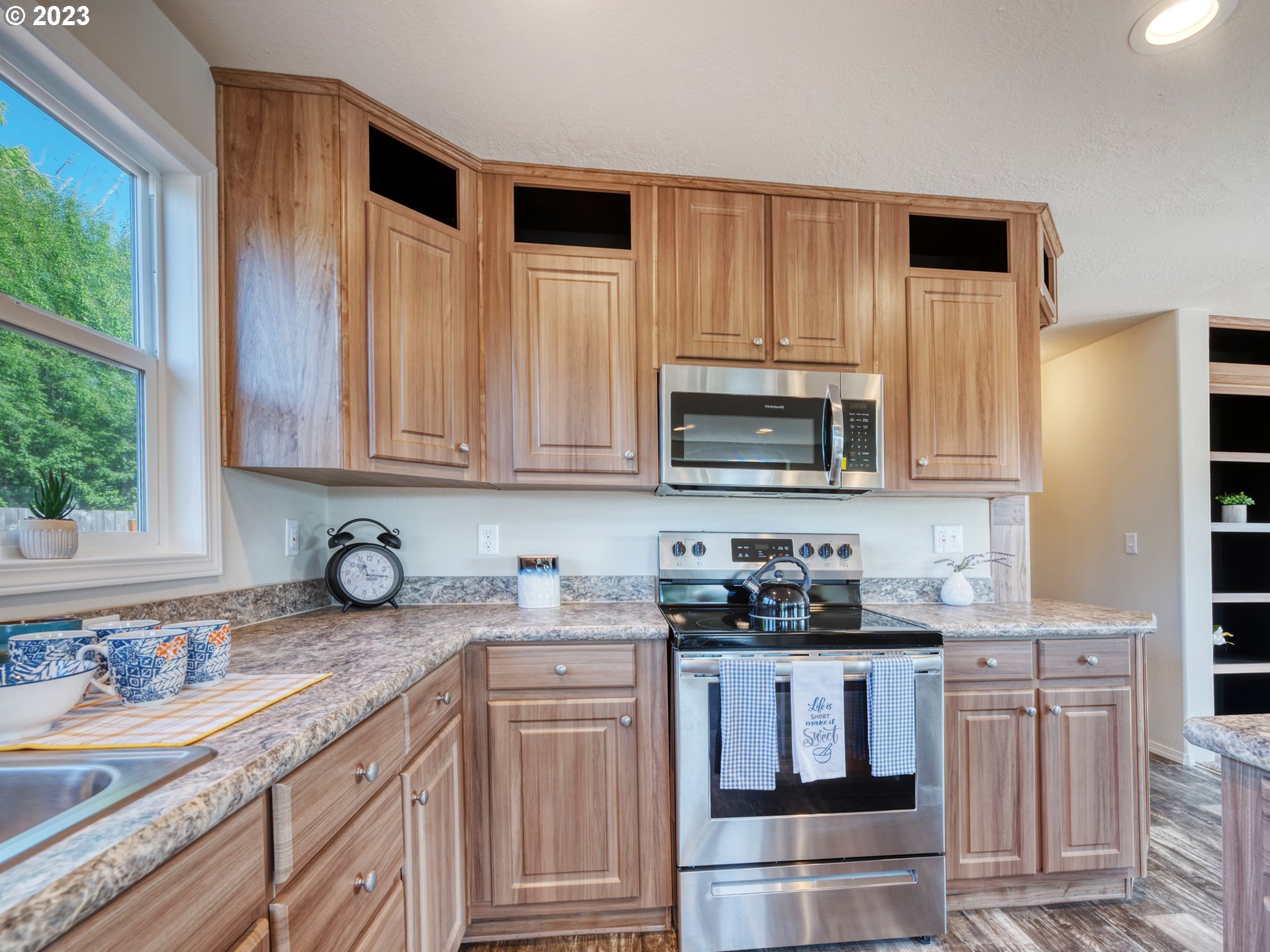 4689 Union Terrace Springfield, OR 97478 - Photo 7 of 24 a kitchen with stainless steel appliances granite countertop white cabinets sink and a granite counter top