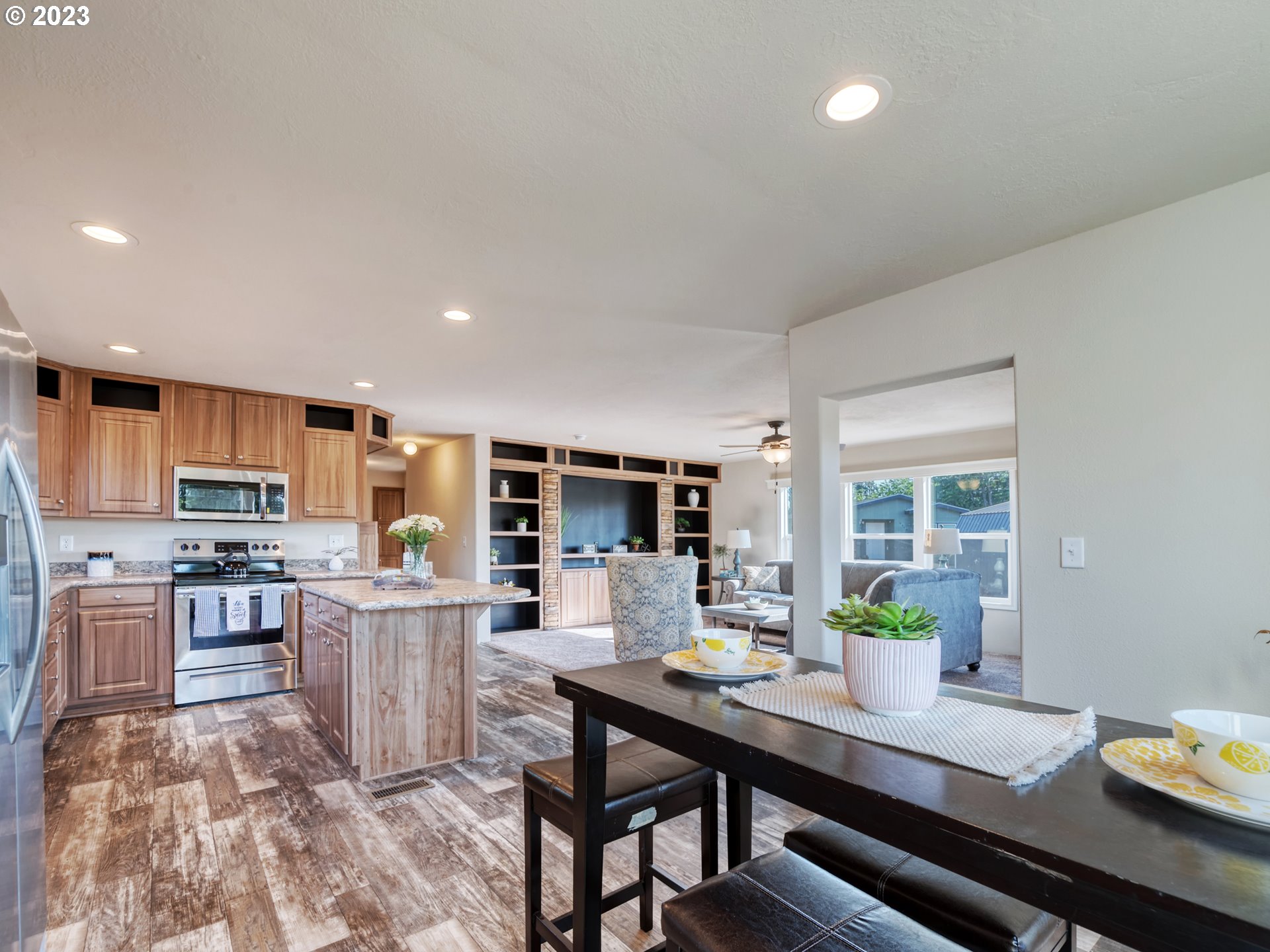 4689 Union Terrace Springfield, OR 97478 - Photo 9 of 24 a room with stainless steel appliances a dining table wooden floor and a view of kitchen