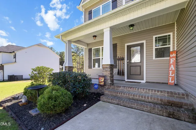 a front view of a house with a garden