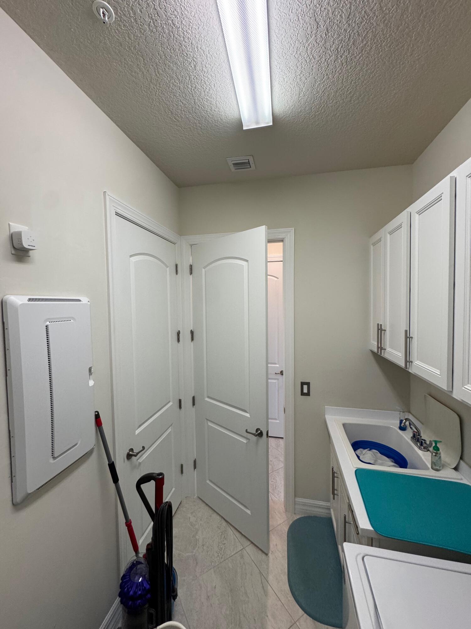 21872 Canadensis Circle, Unit 202 Boca Raton, FL 33428 - Photo 17 of 43 inside laundry room