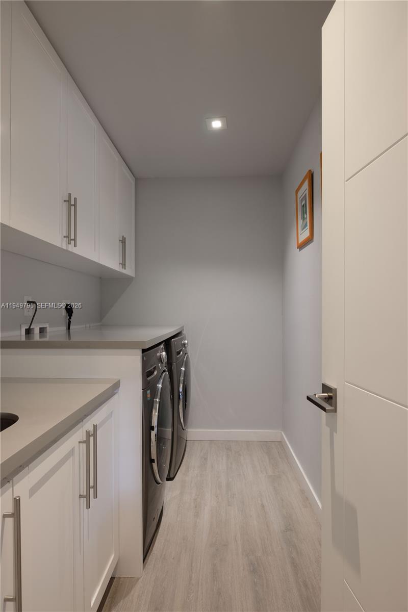6201 Southwest 36th Street Miami, FL 33155 - Photo 14 of 43 a utility room with cabinets washer and dryer