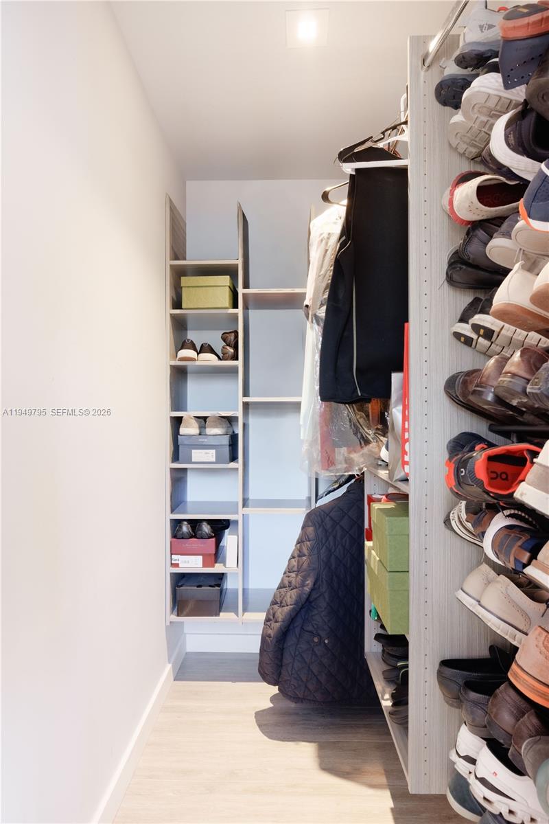 6201 Southwest 36th Street Miami, FL 33155 - Photo 8 of 43 a view of walk in closet with clothes and shoes
