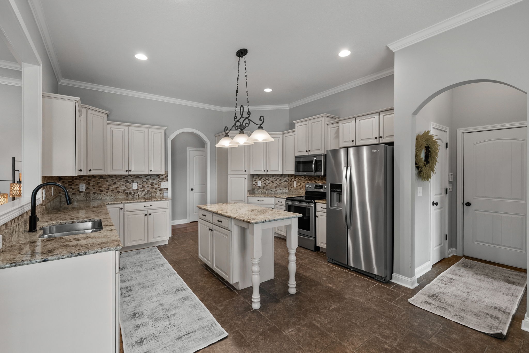 2976 Rossview Road Clarksville, TN 37043 - Photo 13 of 54 a kitchen with stainless steel appliances granite countertop a refrigerator a stove a sink dishwasher a oven with white cabinets and wooden floor
