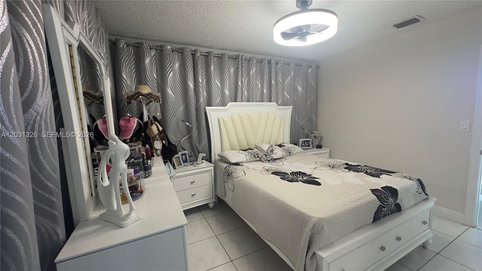 12480 Southwest 189th Street Miami, FL 33177 - Photo 14 of 25 a bedroom with a bed and a window