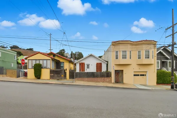 a front view of a house with a street