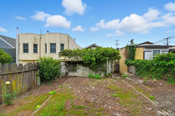 a front view of a house with a yard and potted plants